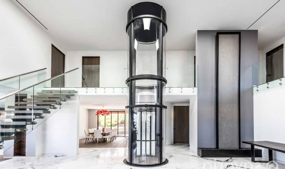 Round clear elevator in center of home entryway